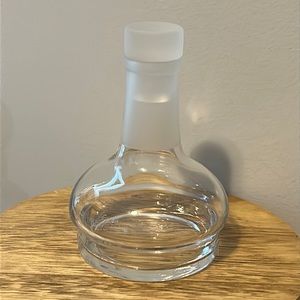 Clear glass bottle with frosted neck and stopper